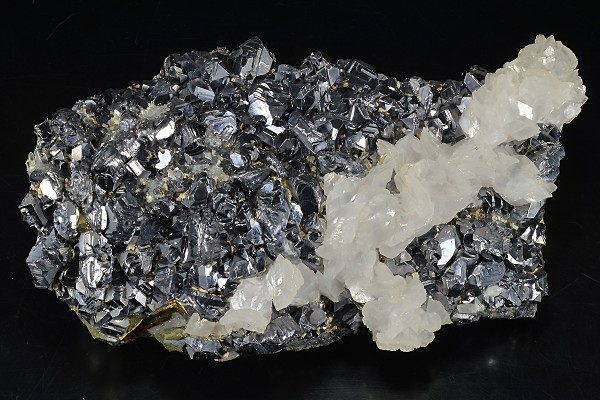 Rhombohedral Calcite set on twinned Galena, Chalcopyrite, Quartz