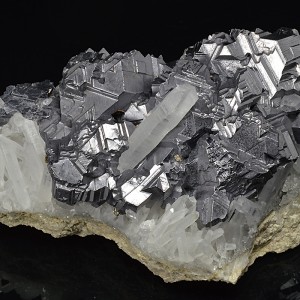 Twinned Galena with Pyrite inclusions set on Quartz